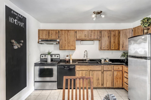 kitchen featuring light tile patterned flooring, appliances with stainless steel finishes, and sink