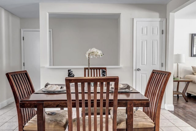 dining area with light tile patterned floors