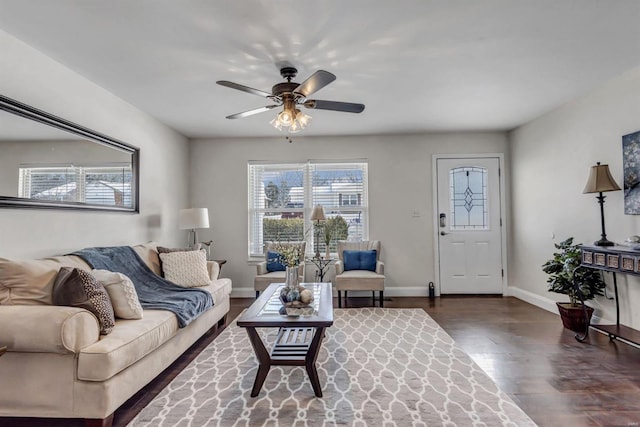 living room with dark wood-type flooring and ceiling fan