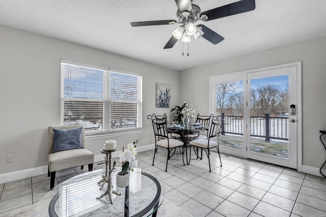 dining room with light tile patterned floors, a textured ceiling, and ceiling fan