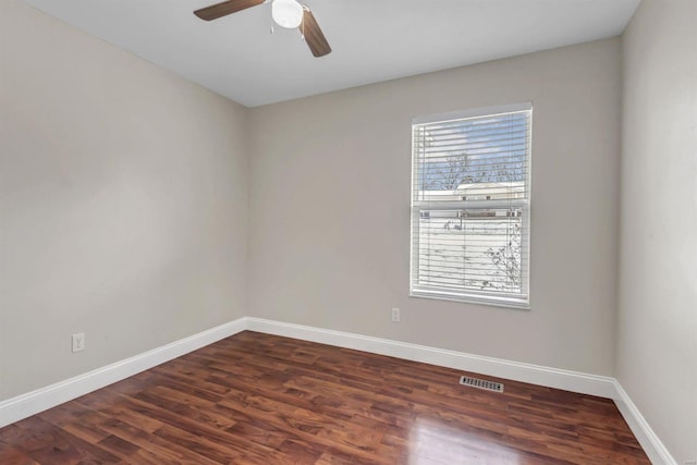 unfurnished room with dark hardwood / wood-style floors and ceiling fan