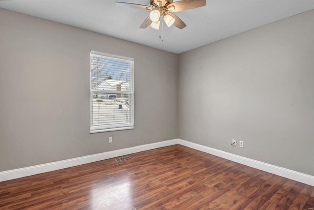 spare room with ceiling fan and dark hardwood / wood-style floors