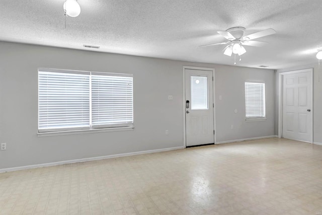 interior space featuring a textured ceiling and ceiling fan