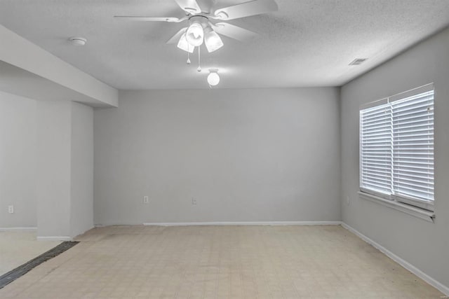 unfurnished room with a textured ceiling and ceiling fan