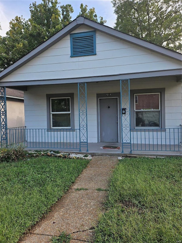 view of front of property with a porch and a front yard