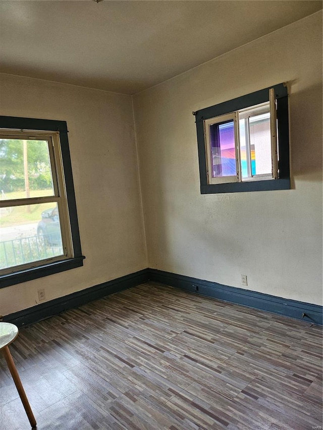 unfurnished room with hardwood / wood-style floors