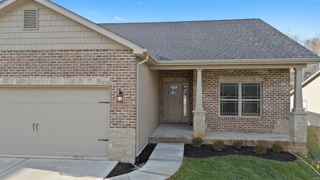 doorway to property featuring a garage and covered porch