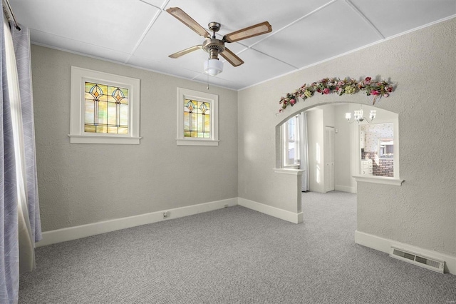 unfurnished room featuring light carpet and ceiling fan with notable chandelier