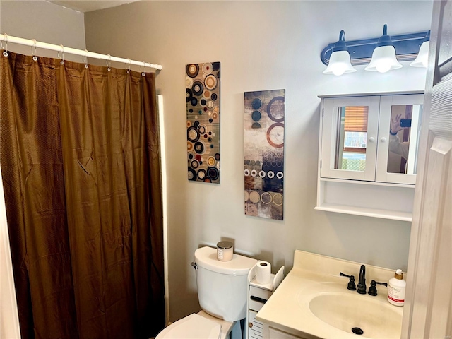 bathroom featuring walk in shower, vanity, and toilet