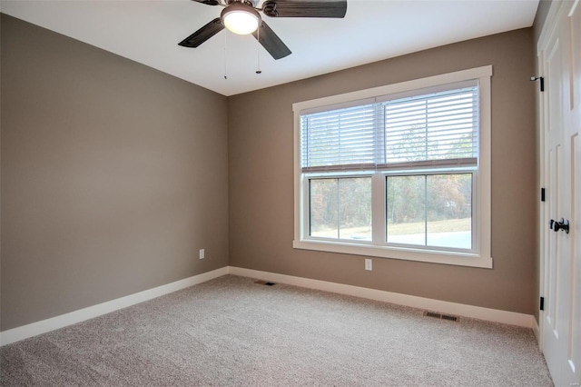 empty room with ceiling fan and carpet