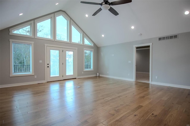 interior space featuring ceiling fan, vaulted ceiling, and light wood-type flooring