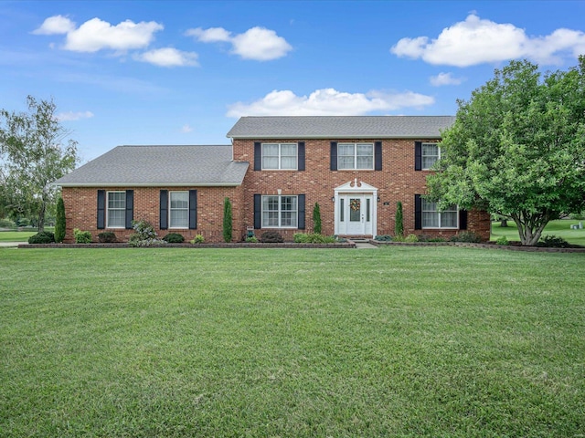 colonial-style house with a front lawn