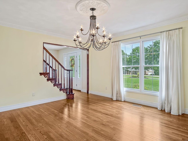 interior space featuring crown molding, a chandelier, and hardwood / wood-style flooring