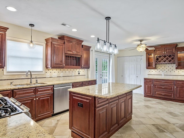 kitchen with stainless steel dishwasher, ceiling fan, pendant lighting, and sink