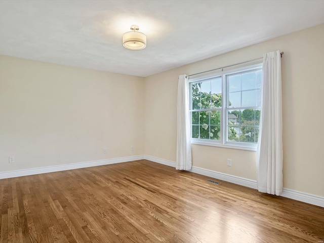 unfurnished room featuring light hardwood / wood-style floors