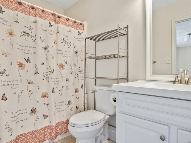 bathroom with toilet, tile patterned flooring, curtained shower, and vanity