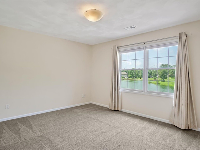 empty room featuring carpet and a water view