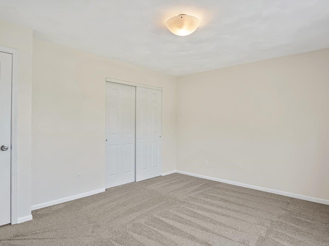 unfurnished bedroom featuring a closet and carpet floors