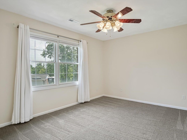 spare room with ceiling fan and carpet flooring