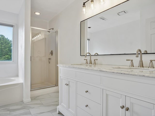 bathroom with vanity and separate shower and tub