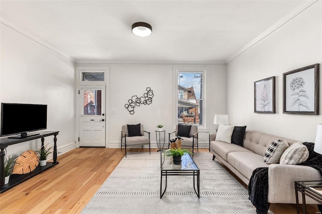 living room with crown molding and hardwood / wood-style floors