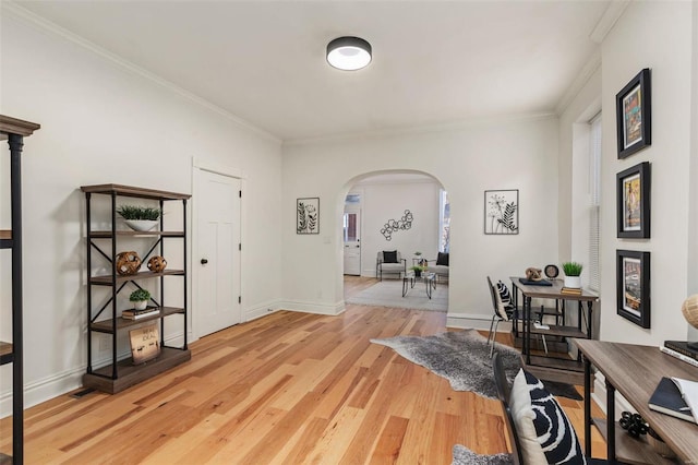 hallway featuring ornamental molding and light hardwood / wood-style flooring