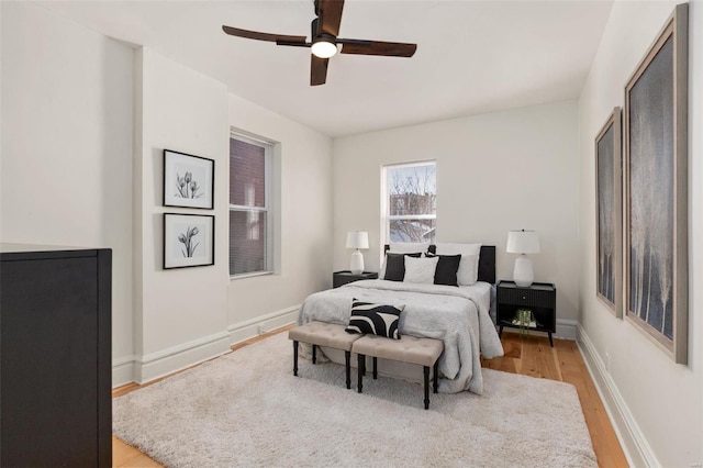 bedroom with ceiling fan and light hardwood / wood-style floors