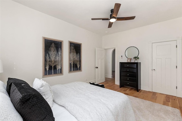 bedroom with ceiling fan and light hardwood / wood-style flooring