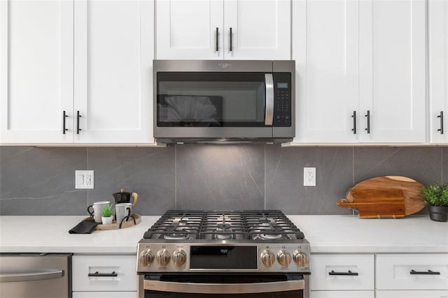 kitchen featuring tasteful backsplash, stainless steel appliances, and white cabinetry