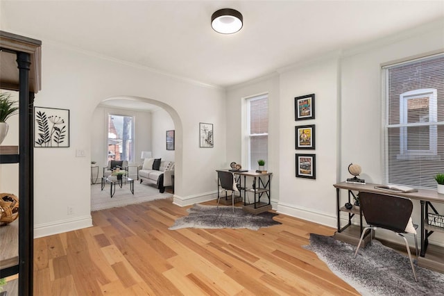 home office with ornamental molding and hardwood / wood-style flooring