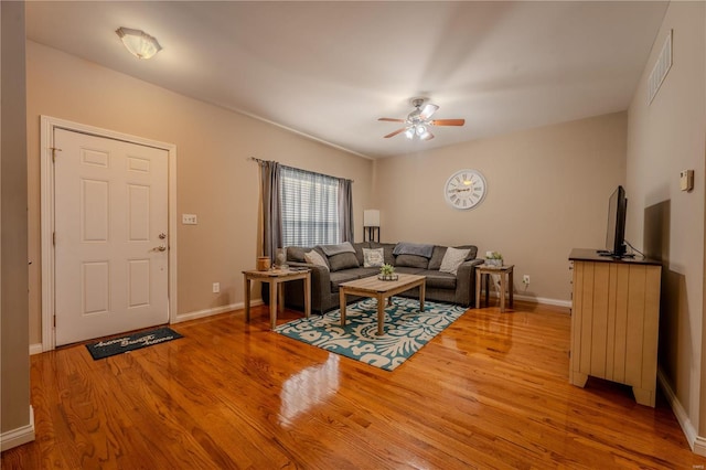 living room with ceiling fan and wood-type flooring