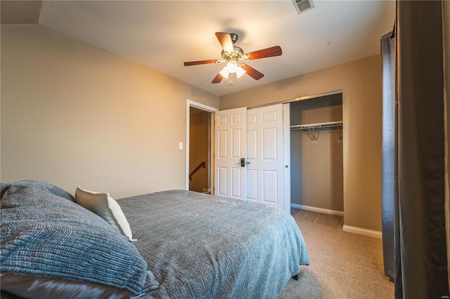 carpeted bedroom featuring lofted ceiling, a closet, and ceiling fan