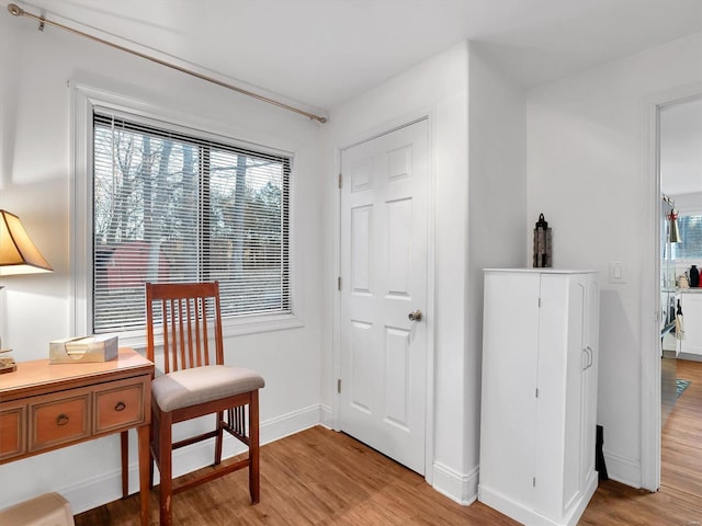 sitting room featuring light wood-style flooring and baseboards