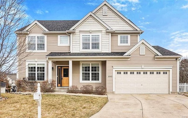 view of front facade featuring a garage and a front lawn