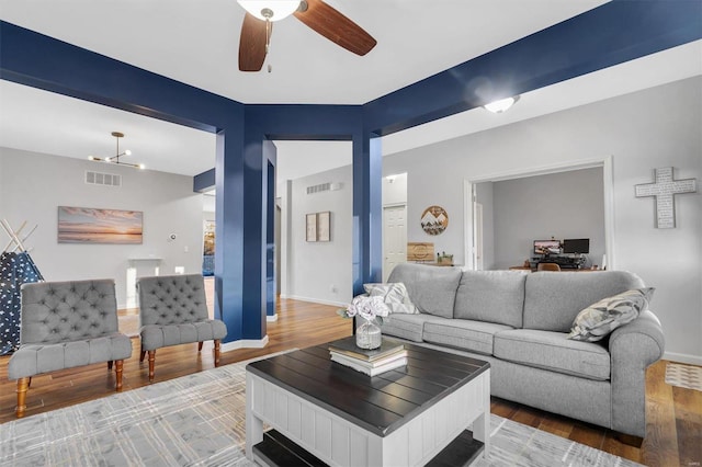 living room featuring wood-type flooring and ceiling fan