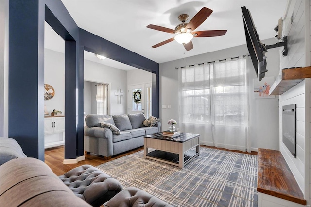 living room with dark hardwood / wood-style floors and ceiling fan