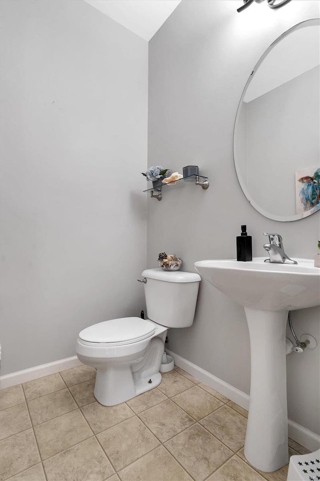 bathroom with tile patterned flooring and toilet