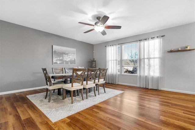 dining space with dark hardwood / wood-style floors and ceiling fan