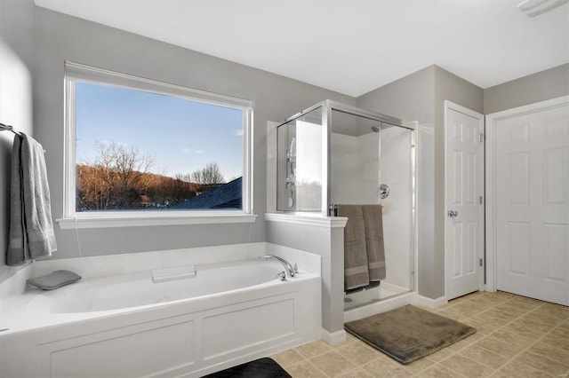 bathroom featuring separate shower and tub and a wealth of natural light