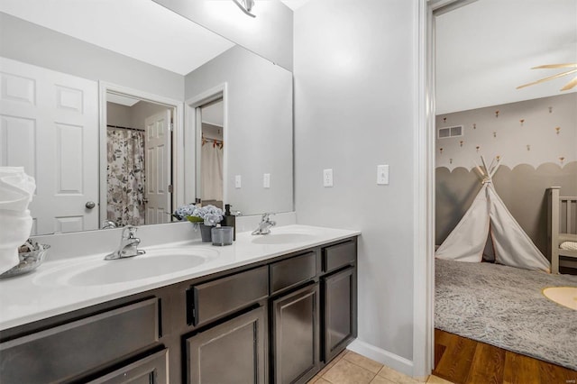 bathroom with ceiling fan and vanity