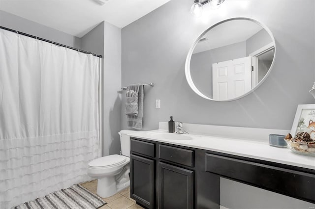 bathroom featuring tile patterned flooring, vanity, and toilet