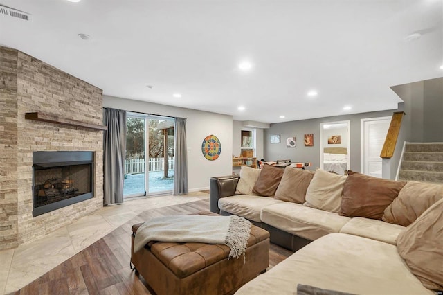 living room featuring a large fireplace and light wood-type flooring