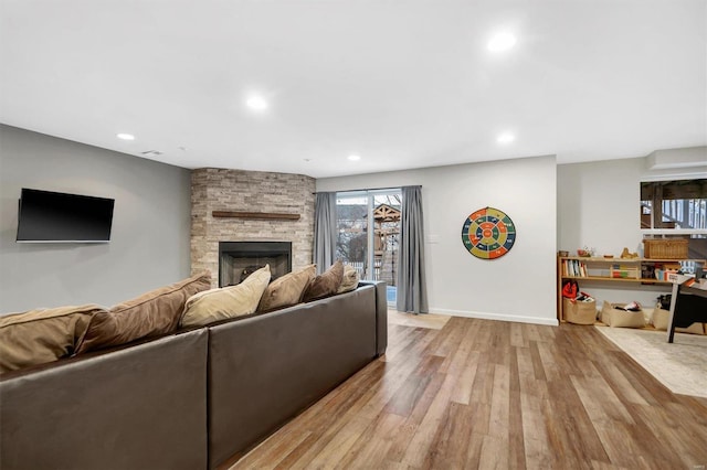 living room featuring a fireplace and light wood-type flooring