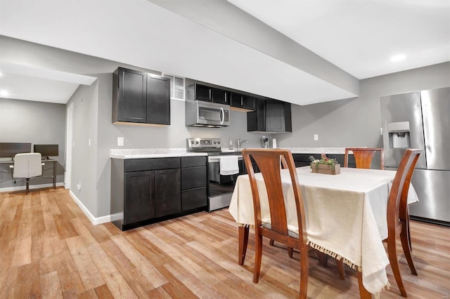 dining area featuring sink and light hardwood / wood-style flooring