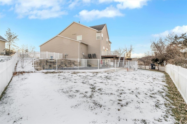 view of snow covered back of property