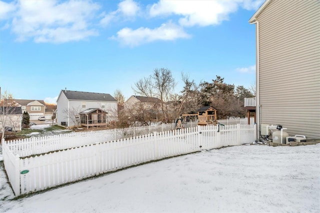 view of snow covered exterior featuring a playground