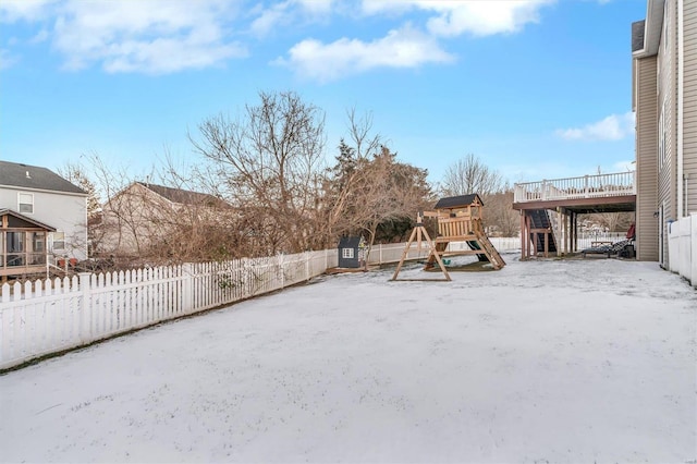 exterior space featuring a playground and a deck