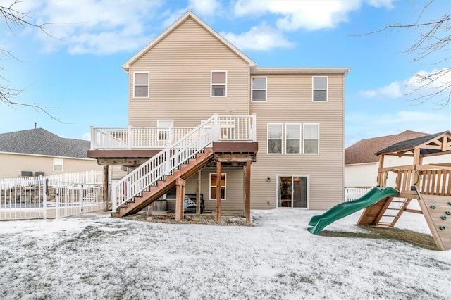 snow covered property featuring a playground