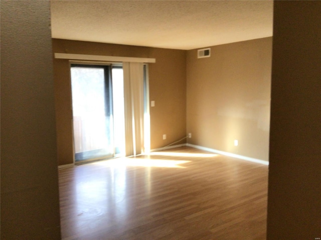 empty room with hardwood / wood-style floors