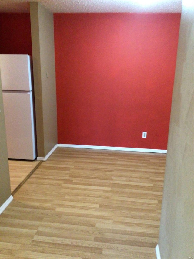 spare room featuring light wood-type flooring